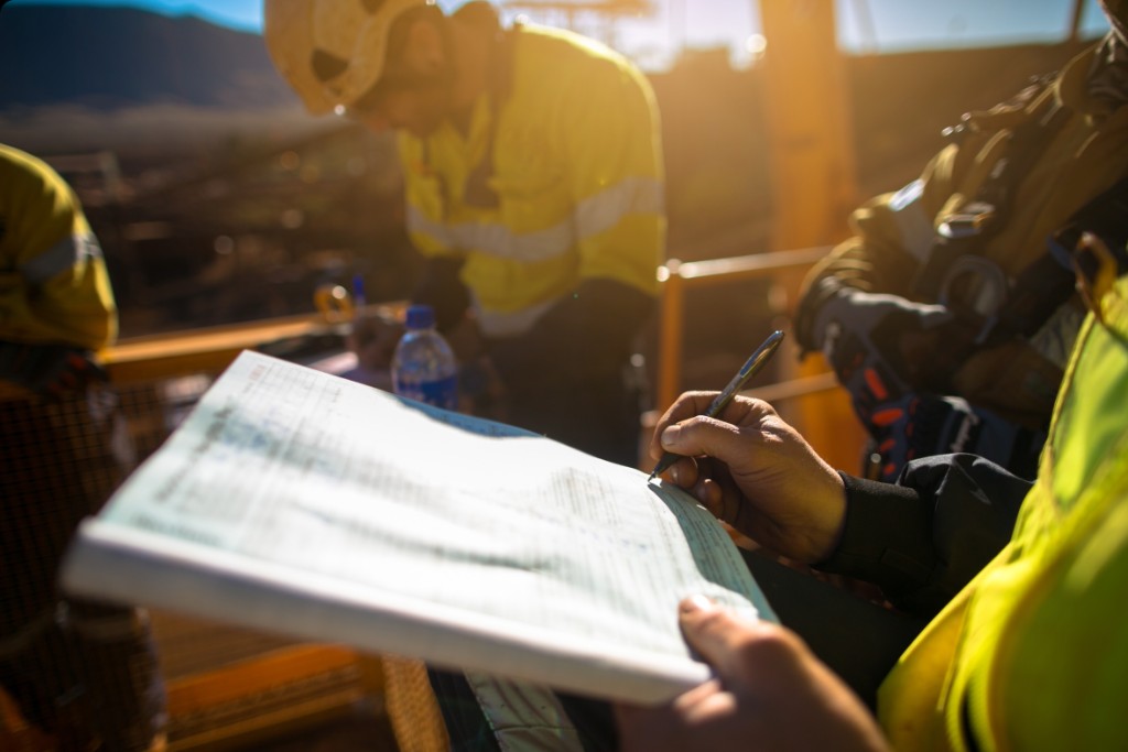 Construction workers reviewing plans on a job site